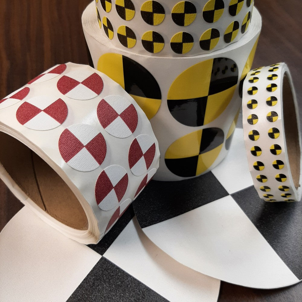 Die-cut circles in either red and white or black and yellow, used as crash test dummy targets