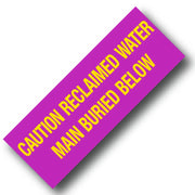 BARRICADE TAPE CAUTION RECLAIMED WATER MAIN BURIED BELOW