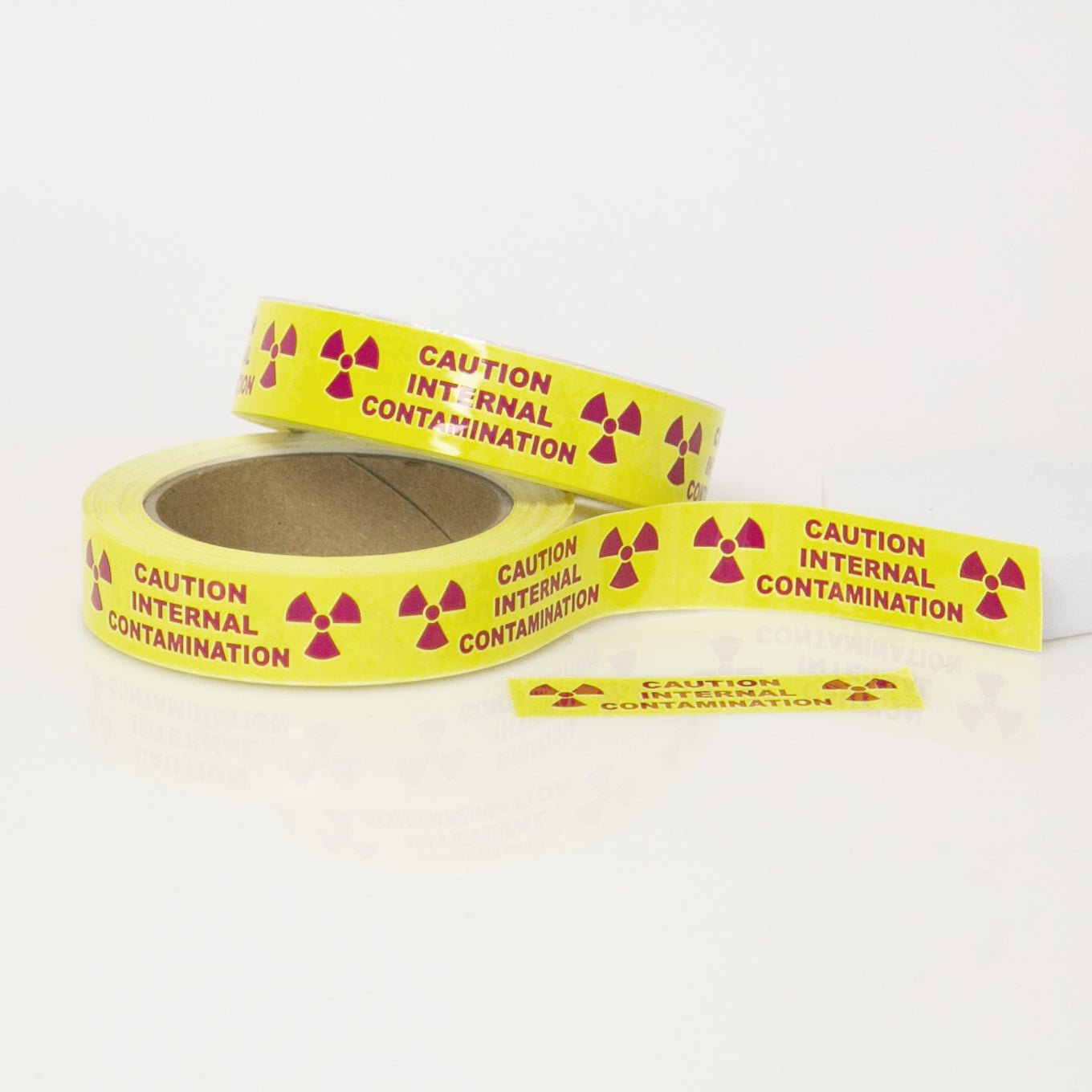 Caution Internal Contamination with Rad Symbols 1" x 3.5" Pieces on 36 yard roll - NADCO Tapes & Labels, Inc.